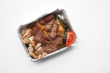 Kebab, traditional turkish meat food with salad on a take away paclet 