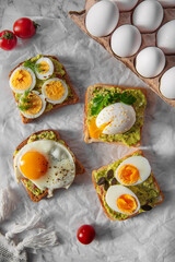 Fototapeta na wymiar toast with guacamole and different kinds of eggs