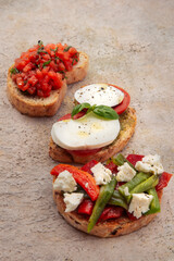 three bruschetta (tomato, mozzarella, and pepper)