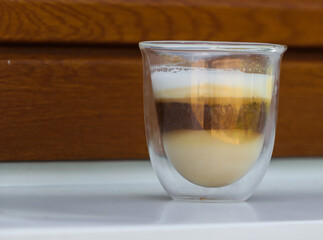 A cup of coffee in a glass cup in the afternoon