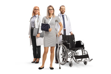 Doctors standing behind a female patient with an arm sling and a crutch