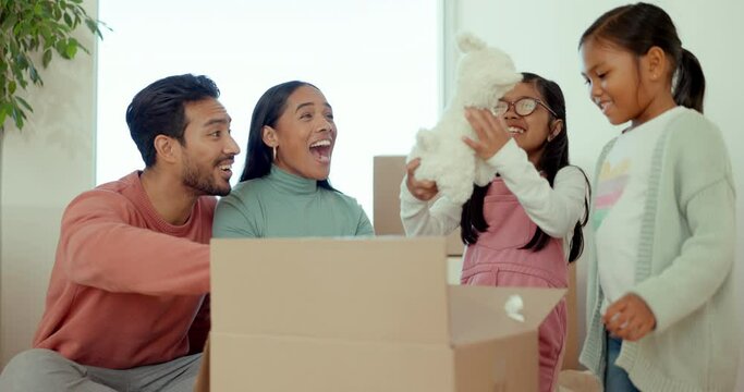 Parents, children and open box in new house, toys and happy celebration for fresh start at property. Mother, dad and girl children and moving with cardboard package, excited together and family home
