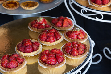 isolated strawberry tarts on a sweets counter at a street food market

