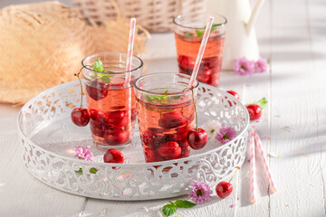 Healthy lemonade with crushed ice and cherries.