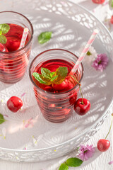 Healthy lemonade with sweet cherries and mint.