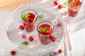 Cold lemonade with crushed ice and cherries.