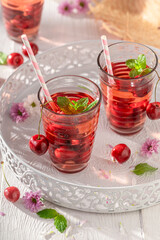 Homemade lemonade with crushed ice and cherries.