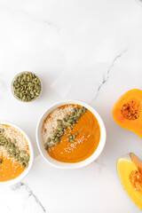 A bowl of pumpkin soup with mashed potatoes and seeds. Autumn menu. Copy space