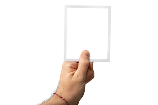 Hand holding a instant photo picture up isolated in black background in very high detail, e.g. hair, copy space - Powered by Adobe