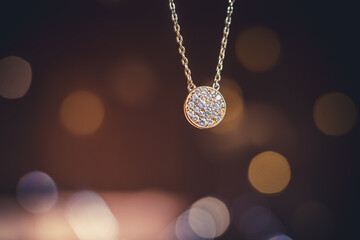 magnificent necklace suspended on a blurred wood background