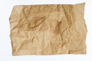 Crumpled paper. Old sheet. Kraft crumpled paper. Paper for packing or filling parcel. Sheet with crumpled texture. Torn list of parchment. Old kraft list. Wrinkled ragged packaging material