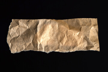 Old-yellowed paper. Piece of parchment. Kraft snippet paper isolated. Wrinkled packaging material....