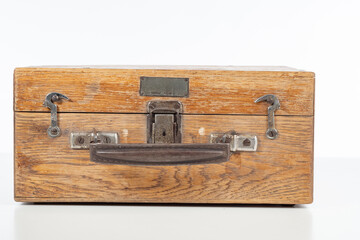 Wooden suitcase. Old chest with carrying handle. Container from boards on white background. Wooden suitcase from last century. Chest with metal hooks. Suitcase for transporting fragile goods