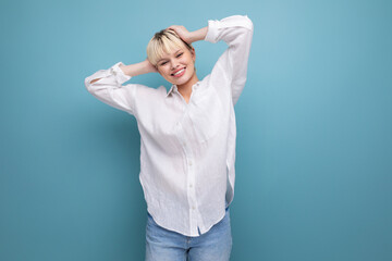Fototapeta premium young pretty caucasian blond career woman in white blouse isolated on blue background with copy space