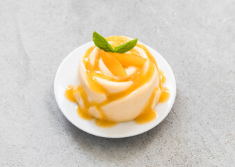 Apricot cream jelly dessert, Panna Cotta with apricot sauce, in the shape of a rose, on a plate....