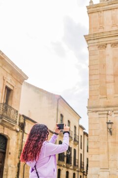 Smartphone technology holiday vacation. Latin American mid-female. Lifestyle photo in Salamanca.
