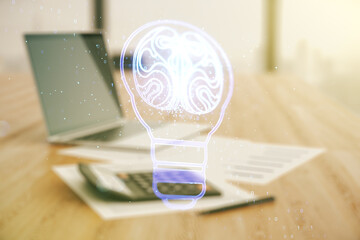 Double exposure of abstract virtual creative light bulb hologram with human brain on blurry calculator with laptop background, idea and brainstorming concept