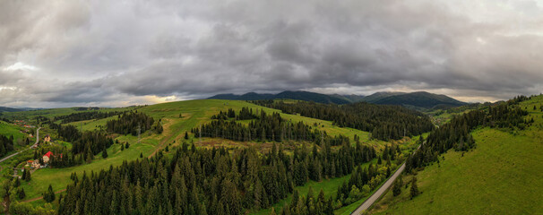 Aerial view of the endless lush pastures of the Carpathian expanses and agricultural land. Rural mountain landscape, drone panoramic picture. Ukraine.