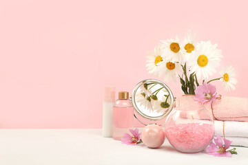 Spa and wellness composition with fragrant rose water, sea pink salt, orchid and chamomile flowers,...
