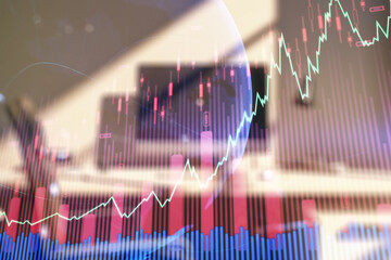 Multi exposure of abstract financial graph with world map and modern desktop with pc on background, financial and trading concept