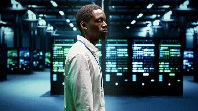 IT admin walking in server farm performing data backups and providing centralized storage. Serviceman debugging Uninterruptible Power Supply ensuring operational continuity