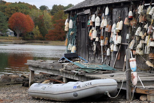 low tide with boat on sand at Cape Neddick Lobster Pound, York, Me and a wall of buoys October 23 2021 
