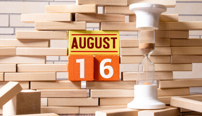 August 16th. Image of august 16 wooden color calendar on blue background. Summer day.