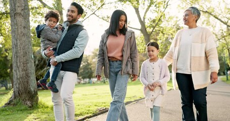 Nature, bonding and family on a walk in a park for fresh air, exercise and conversation together. Happy, smile and kids with their parents and grandmother talking in a green garden for spending time.