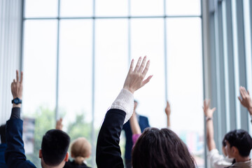 Business person raising hand during seminar. Hand up in conference asking to answer a question in...