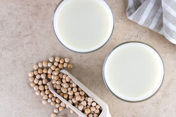 Obraz na płótnie Canvas Chickpea milk with chickpeas on a beige background. Top view. 