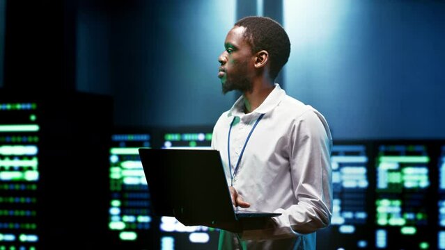 IT programmer setting up high tech facility advanced firewalls, intrusion detection systems and security updates. Cybersecurity supervisor preventing hacking, malware, and denial of service attacks