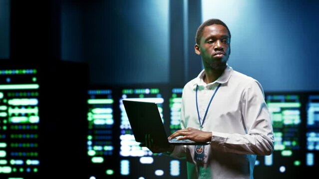 Admin using laptop to set up supercomputer hub infrastructure advanced firewalls and intrusion detection systems. Cybersecurity professional preventing hacking, malware, and phishing attacks