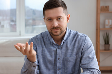 Man having video call at home, view from web camera