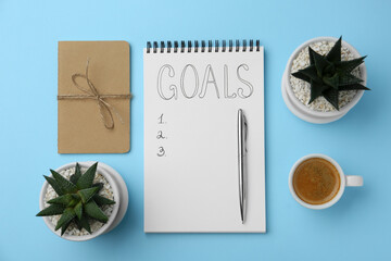 Planning concept. Flat lay composition with empty list of goals in notebook and coffee on light blue background