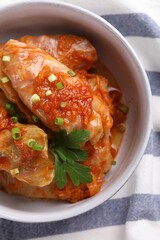 Delicious stuffed cabbage rolls cooked with homemade tomato sauce on table, top view