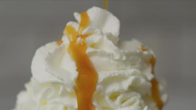 Whipped cream with caramel drizzle slow motion