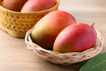 Mango fruit (Palmer mango) in basket on wooden background, Tropical fruit