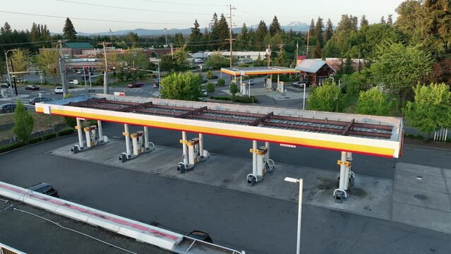 Aerial view pulling away from a vacant gas station in America.