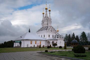 Fototapeta premium View of the Odigitrievsky Church on the territory of the Vyazma Ioanno-Predtechensky Monastery on a sunny day with clouds, Vyazma, Smolensk region, Russia