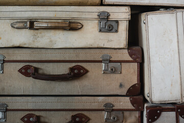 A pile of suitcases, well-worn from years of travel.