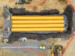 Yellow underground storm water detention mitigation units on a construction site ready to be...