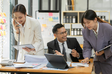 Group of asian business people working, discussing new projects together, having fun at the office.