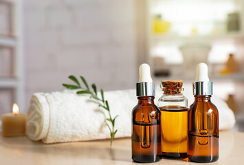 Bottles on the background of the spa room. Skin care serum or natural cosmetics with essential oil. face and body beauty concept. Spa concept. Place for text. - obrazy, fototapety, plakaty