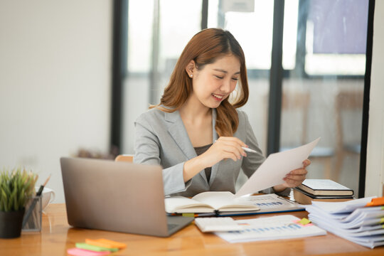 Asian business woman looking at financial documents