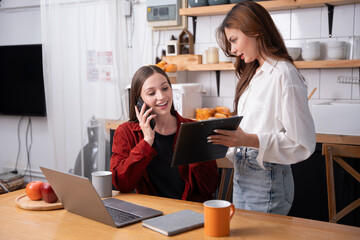 Asian businesswoman using laptop or tablet to work, discuss and discuss during company holidays.
