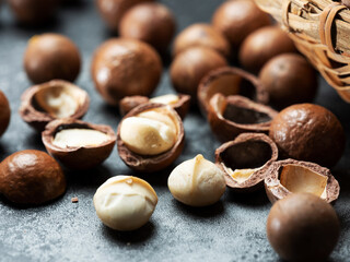 Roasted macadamia nuts on a dark background
