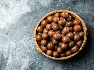 Roasted macadamia nuts on a dark background