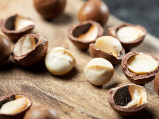 Roasted macadamia nuts on wooden background