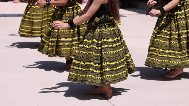 Synchronized hula dance steps with bare feet