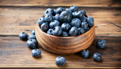 Freshly picked blueberries in a wooden bowl on a wooden background. Healthy food and nutrition.